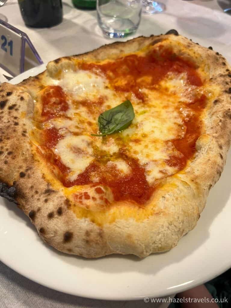 Italian margherita pizza served on a table in a restaurant in Rome.