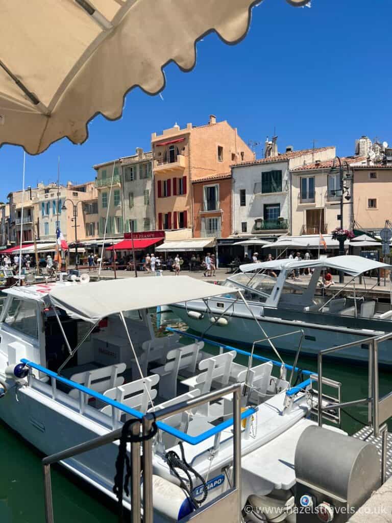 The port village of Cassis, South of France, Provence. Pastel houses and boats as seen from the water.