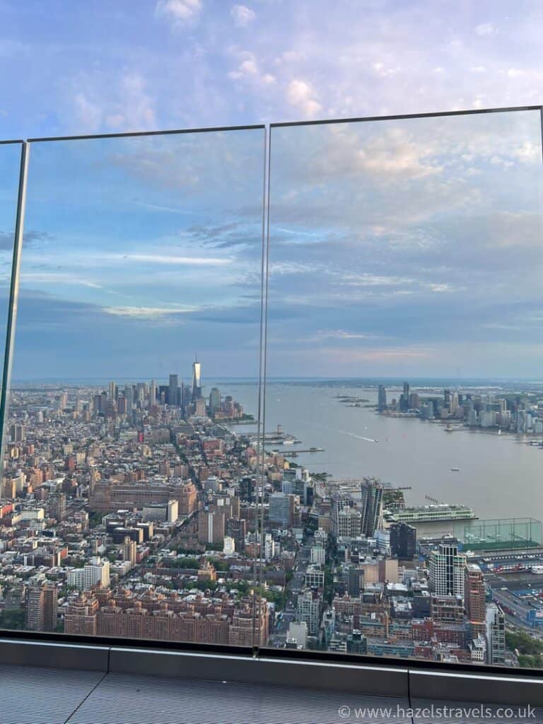 Experience the breathtaking view of the New York City skyline from Edge NYC, where towering buildings and the Hudson River unfold before you as daylight gracefully fades.