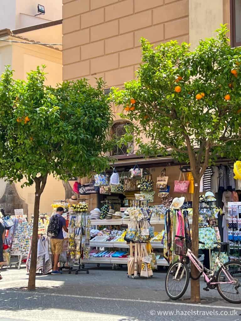 Sorrento outdoor shopping with orange trees and a bicycle