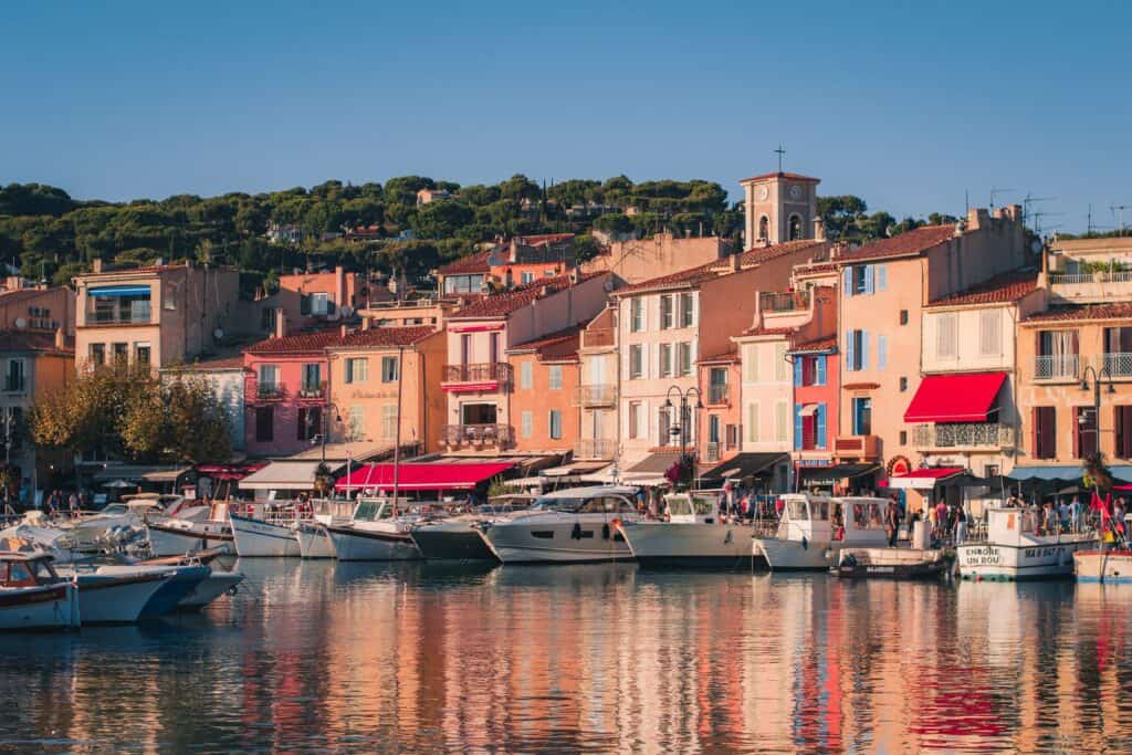 The port village of Cassis, South of France, Provence. Pastel houses and boats as seen from the water.