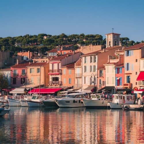 The port village of Cassis, South of France, Provence. Pastel houses and boats as seen from the water.