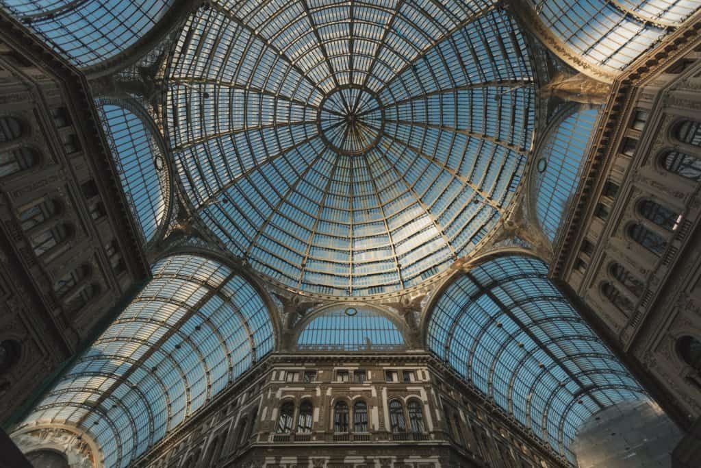 An ornate circular rooftop, picture taken from inside the building looking up at the circular design