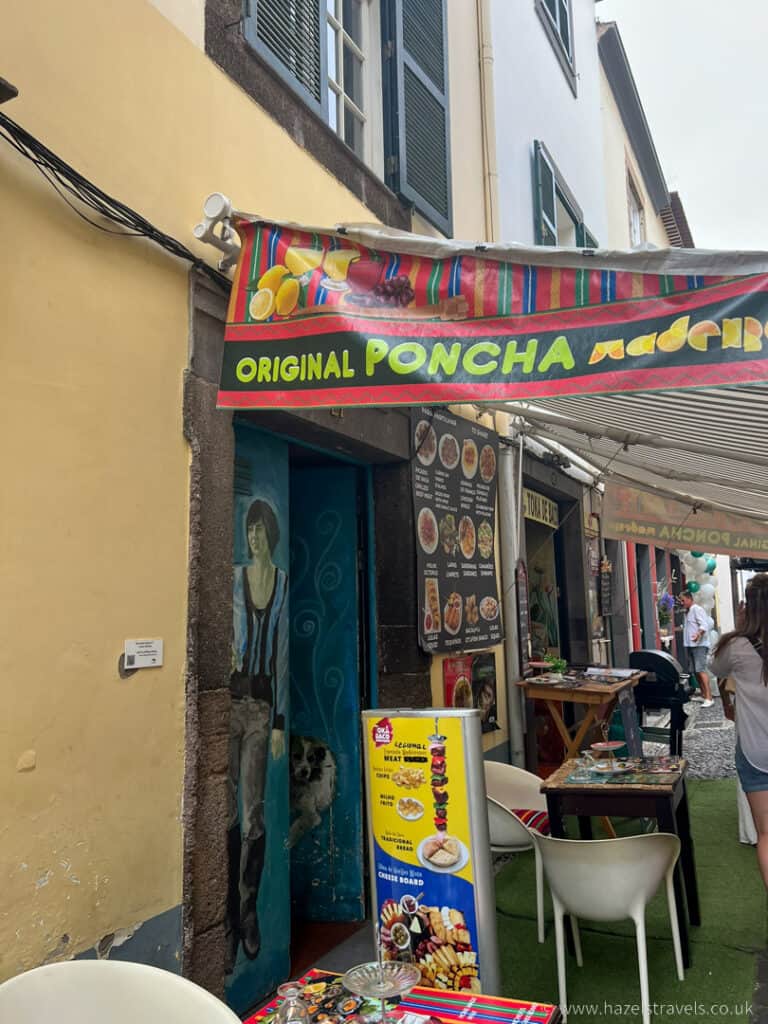 A restaurant with tables and chairs in front of it in Santa Maria Street Funchal
