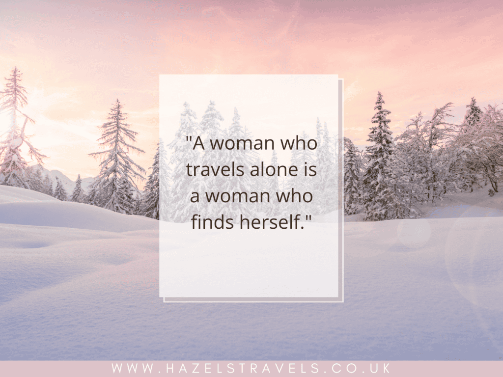 Quote about solo female travel over a snowy landscape with sunlit trees and a pinkish sky. Website URL at the bottom.
