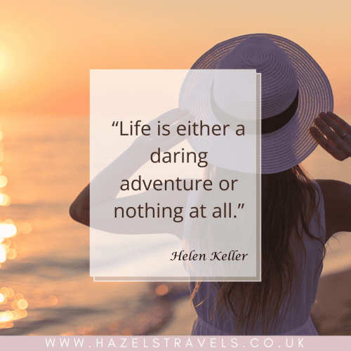 A woman in a white hat looks at a sunset over the ocean. The overlay text reads, “Life is either a daring adventure or nothing at all.” — Helen Keller. Website URL at the bottom.