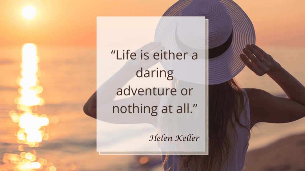 A woman in a white hat looks at a sunset over the ocean. The overlay text reads, “Life is either a daring adventure or nothing at all.” — Helen Keller. Website URL at the bottom.