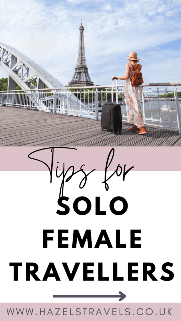 Woman in a dress and hat stands on a bridge with a suitcase, looking at the Eiffel Tower. Text: "Tips for Solo Female Travellers." Website: "www.hazelstravels.co.uk".