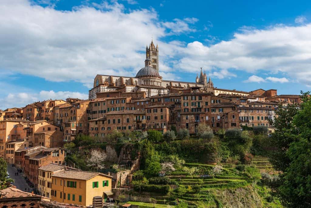 Ancient Italian hillside town with colourful buildings and scenic terraced gardens, showcasing historic architecture in a picturesque setting. Perfect for travel and cultural exploration.