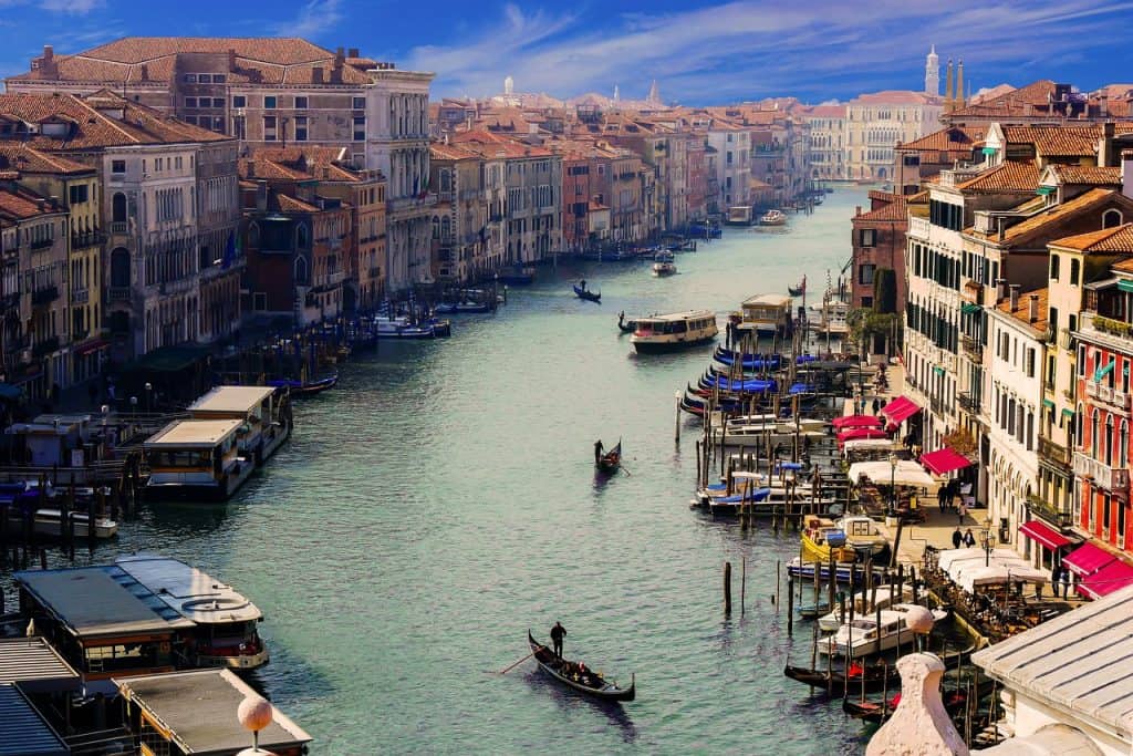 Venetian Grand Canal with historic buildings, boats, and gondolas, capturing the charm and beauty of Venice, Italy, ideal for travel enthusiasts and photography fans.