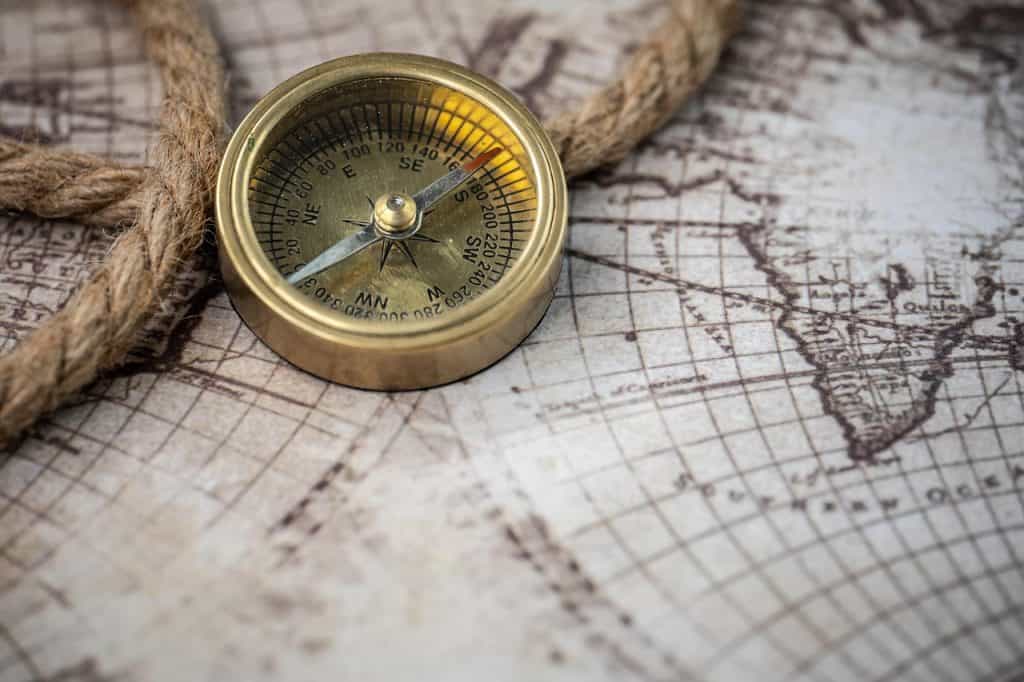 Vintage brass compass on old world map, symbolising travel and exploration for Hazel's Travels SEO content.