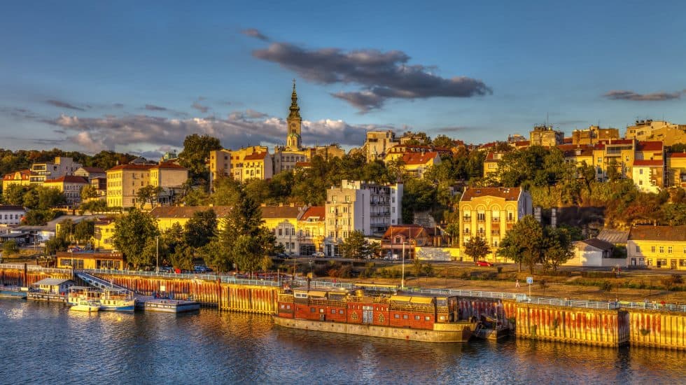 Vibrant cityscape of Bratislava at sunset showcasing historic buildings, riverfront, and Dóm svätého Martina, capturing the charm of Slovakia's capital.