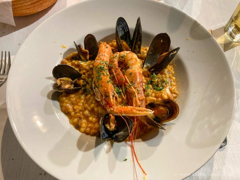 Delicious seafood paella with prawns and mussels served on a white plate, showcasing traditional Spanish cuisine at Hazel's Travels. Perfect for seafood lovers and travel enthusiasts.
