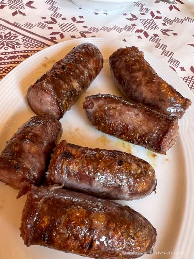 Succulent cooked sausages served on a white plate, ideal for traditional British cuisine. Perfect for food lovers seeking authentic sausages and hearty meals.