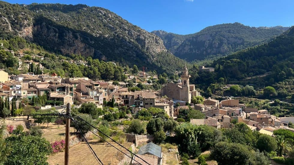 Picturesque mountain village in Provence, France, with historic buildings, lush greenery, and scenic hills under a bright blue sky, perfect for travel and exploration.