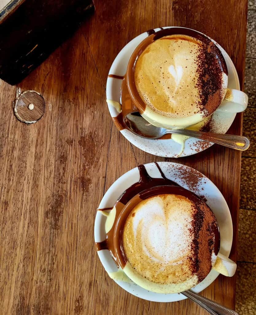 Hot chocolate at The Crazy Bear, London - Two decadent cups of thick hot chocolate topped with whipped cream and cocoa powder.