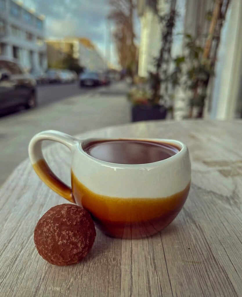Melt Chocolates, London — Cup of luxury hot chocolate with a truffle served on the side at Melt Chocolates in Notting Hill.