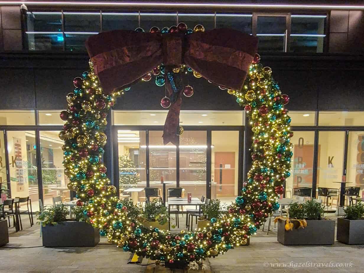 Festive wreath with lights and greenery at a London doorway