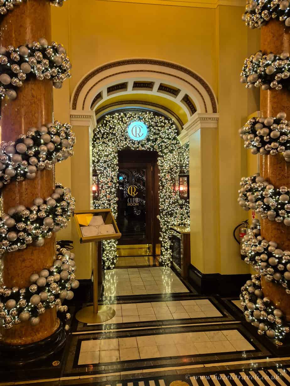 Festive hallway inside The Dome Edinburgh, decorated with Christmas trees and twinkling garlands.