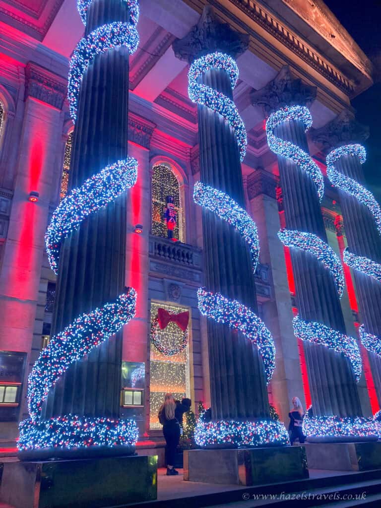 The Dome Edinburgh exterior lit with blue and red Christmas lights on George Street at night.