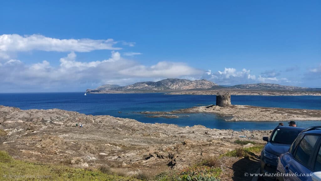 La Pelosa Beach, Stintino, Sardinia — View of La Pelosa’s turquoise waters and Torre della Pelosa tower under a bright blue sky.