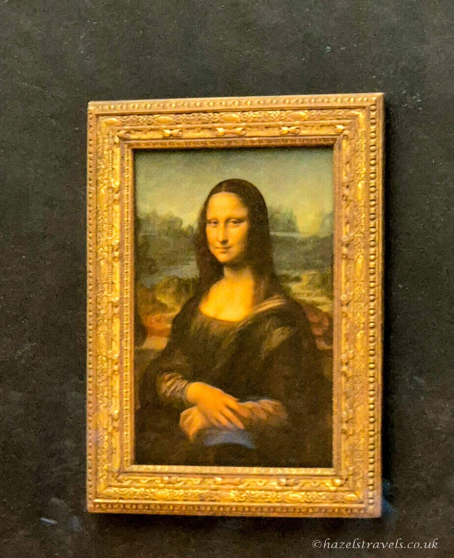 Mona Lisa by Leonardo da Vinci, Louvre Museum — The world-famous portrait of Lisa Gherardini displayed behind glass.