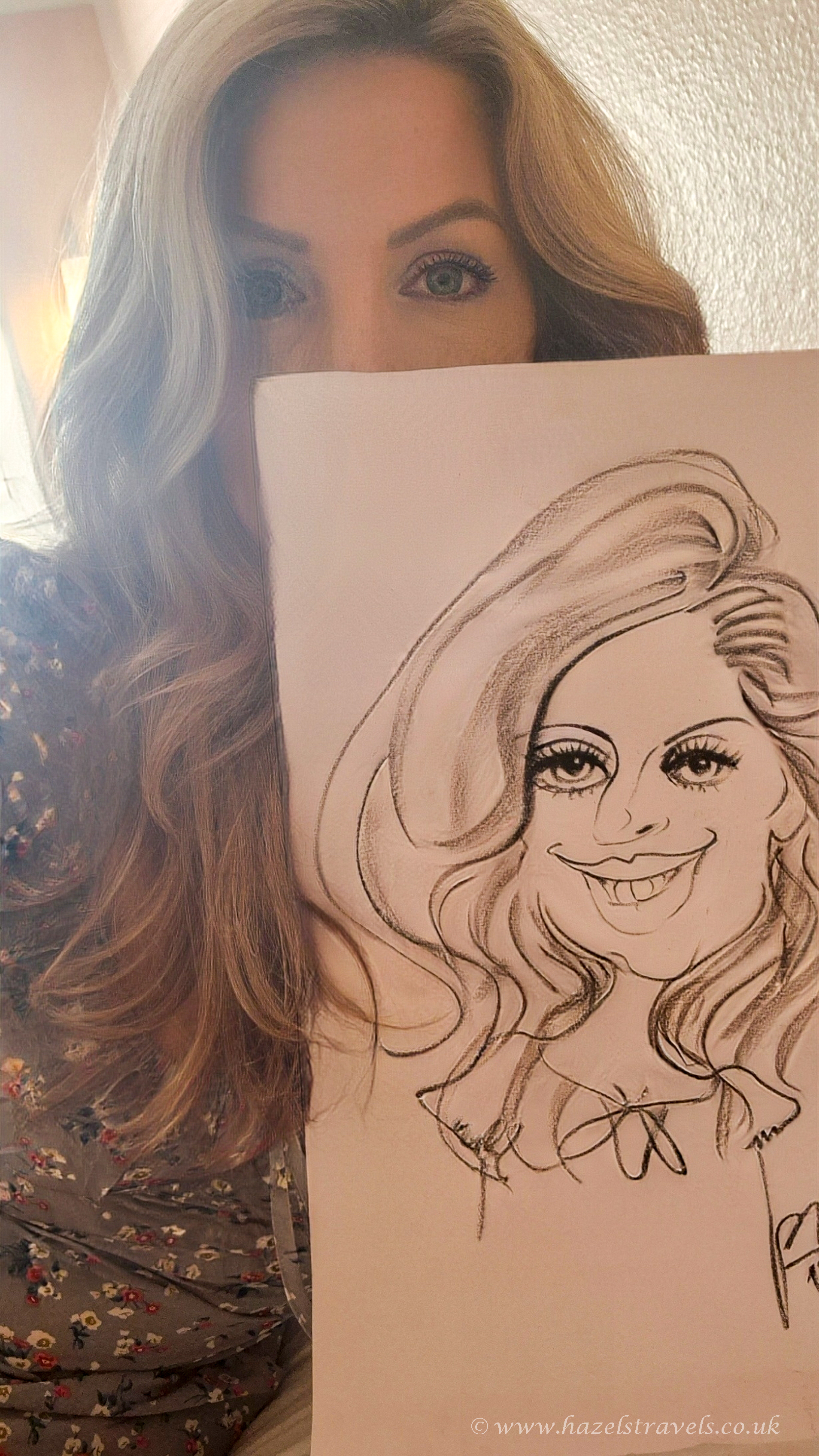 Woman with long blonde hair holding a hand-drawn caricature portrait from a Montmartre street artist in Paris.