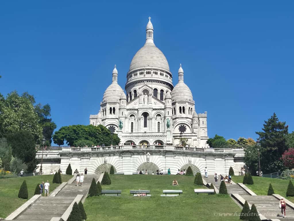 Sacré-Cœur Basilica, Paris — The white domes of the Sacré-Cœur glowing in the sun atop Montmartre hill.