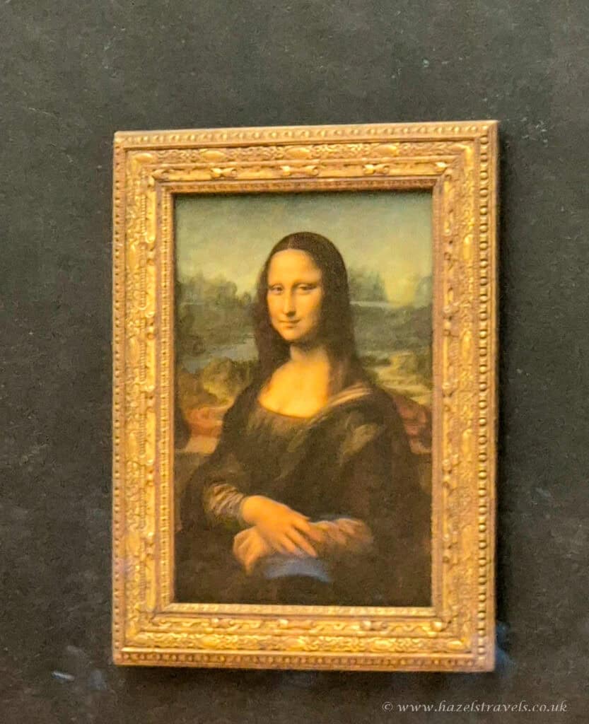 Mona Lisa at the Louvre, Paris — The famous Leonardo da Vinci painting displayed inside the Louvre Museum.