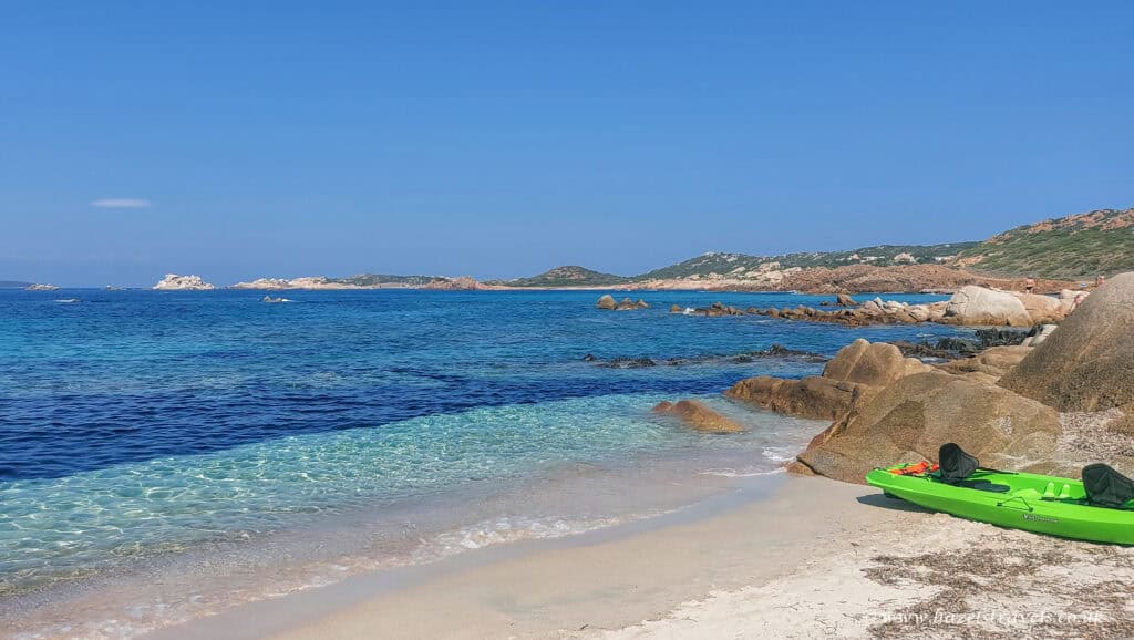 Crystal-clear beach, La Maddalena — Sparkling turquoise water and pale sand on one of La Maddalena’s scenic coves.
