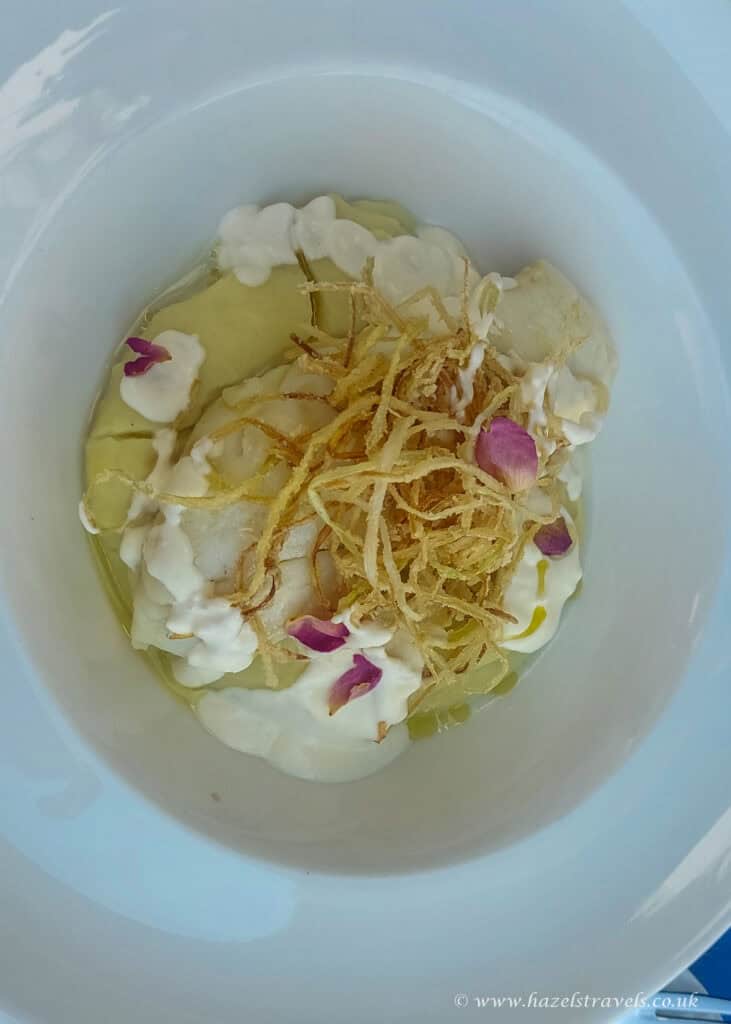 Salt cod with fried online and edible flowers at a local restaurant.