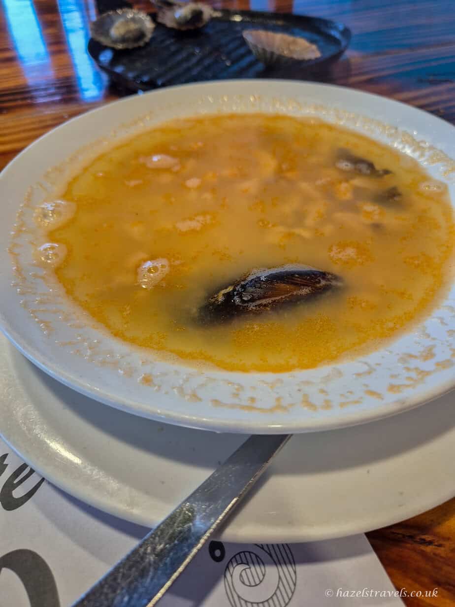 Close-up of a traditional Canarian fish soup with mussels served at a local restaurant in La Palma.