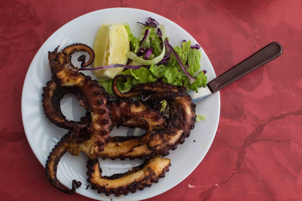 Grilled octopus with salad and boiled potatoes on a plate, a popular dish in the Canary Islands.