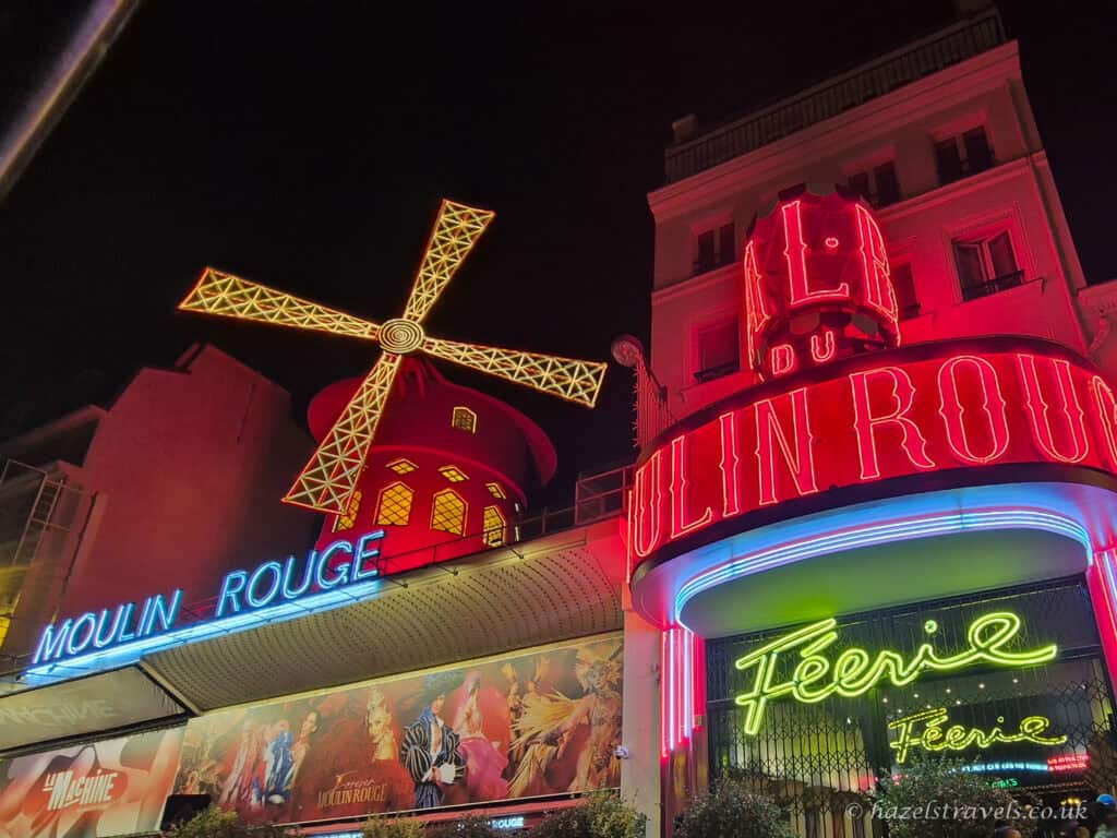 Moulin Rouge neon lights, Paris — Brightly lit façade of the Moulin Rouge with colourful neon signage.