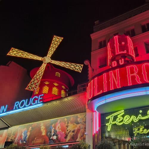 Moulin Rouge neon lights, Paris — Brightly lit façade of the Moulin Rouge with colourful neon signage.