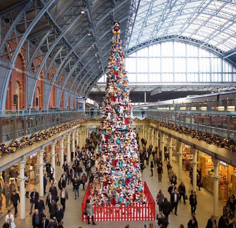 Colourful Christmas tree decorated with red, blue, yellow and green toys and ornaments at St Pancras International.