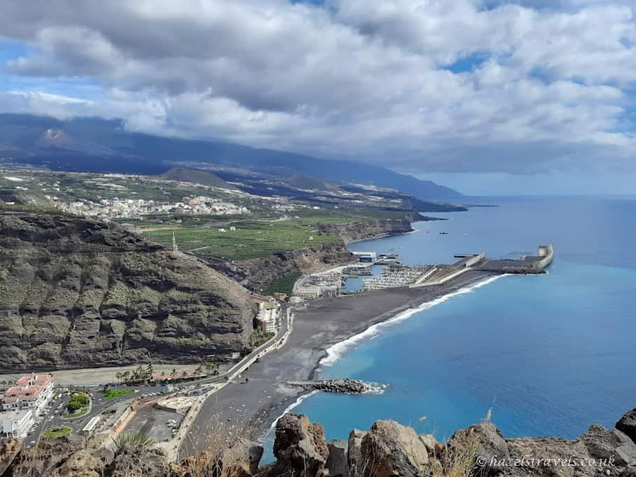 Sweeping coastal view of Tazacorte and surrounding farmland under moody skies