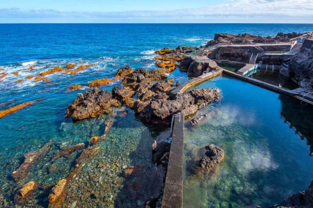 Aerial view of the natural pools at Barlovento, La Palma, Canary Islands. Volcanic rock with man made walking platforms aross the pools.