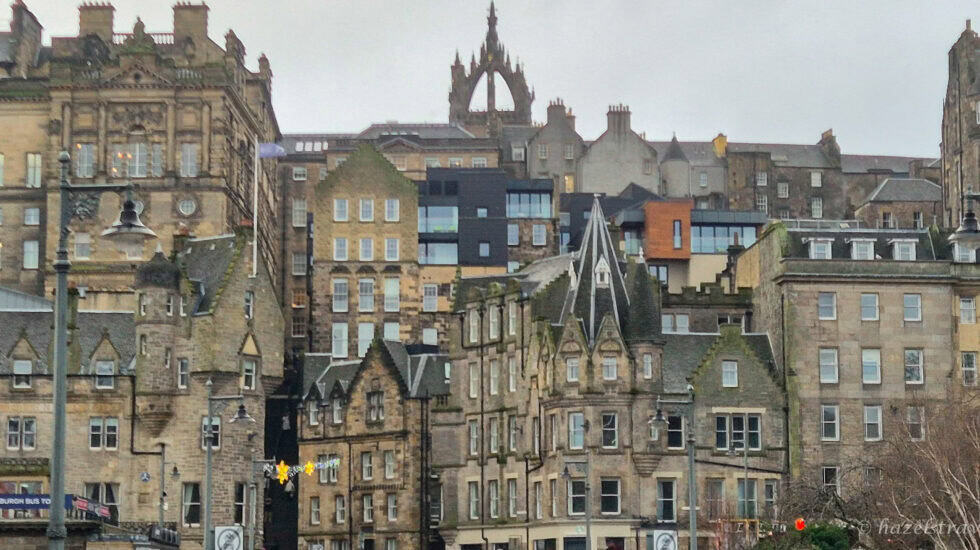 View of Edinburgh’s Old Town skyline with layered historic stone buildings and rooftops rising up the hillside