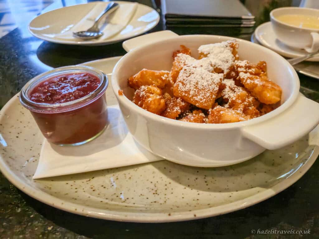 Traditional Kaiserschmarrn in Vienna, shredded Austrian pancake with icing sugar and plum compote.