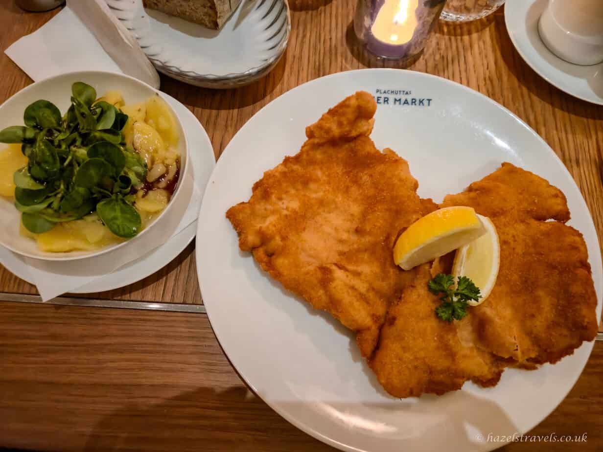 Traditional Wiener Schnitzel with lemon and Viennese potato salad served at Restaurant Neues Markt in Vienna.