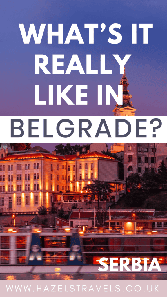 Pinterest graphic with the text “What’s it really like in Belgrade?” featuring an evening view of Belgrade’s waterfront, with historic buildings illuminated by warm lights and the top of a church tower lit against a purple sky. Includes the word “Serbia” and the website hazelstravels.co.uk.