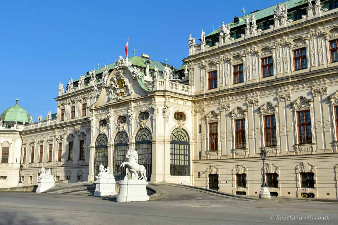 Upper Belvedere Palace in Vienna in winter with its pale cream exterior, green copper roof details and clear blue sky
