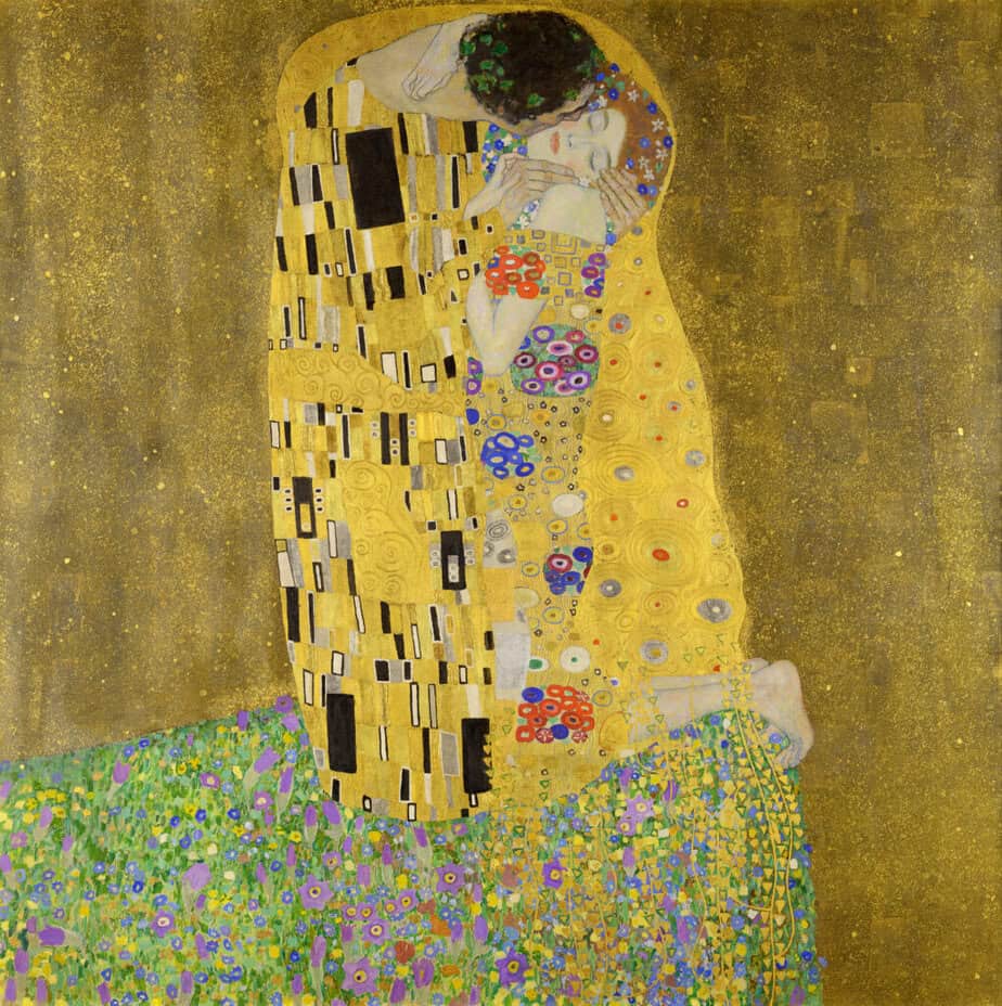 Gustav Klimt’s The Kiss (displayed in Vienna, Austria) featuring an embracing couple wrapped in gold patterned robes standing in a flower meadow