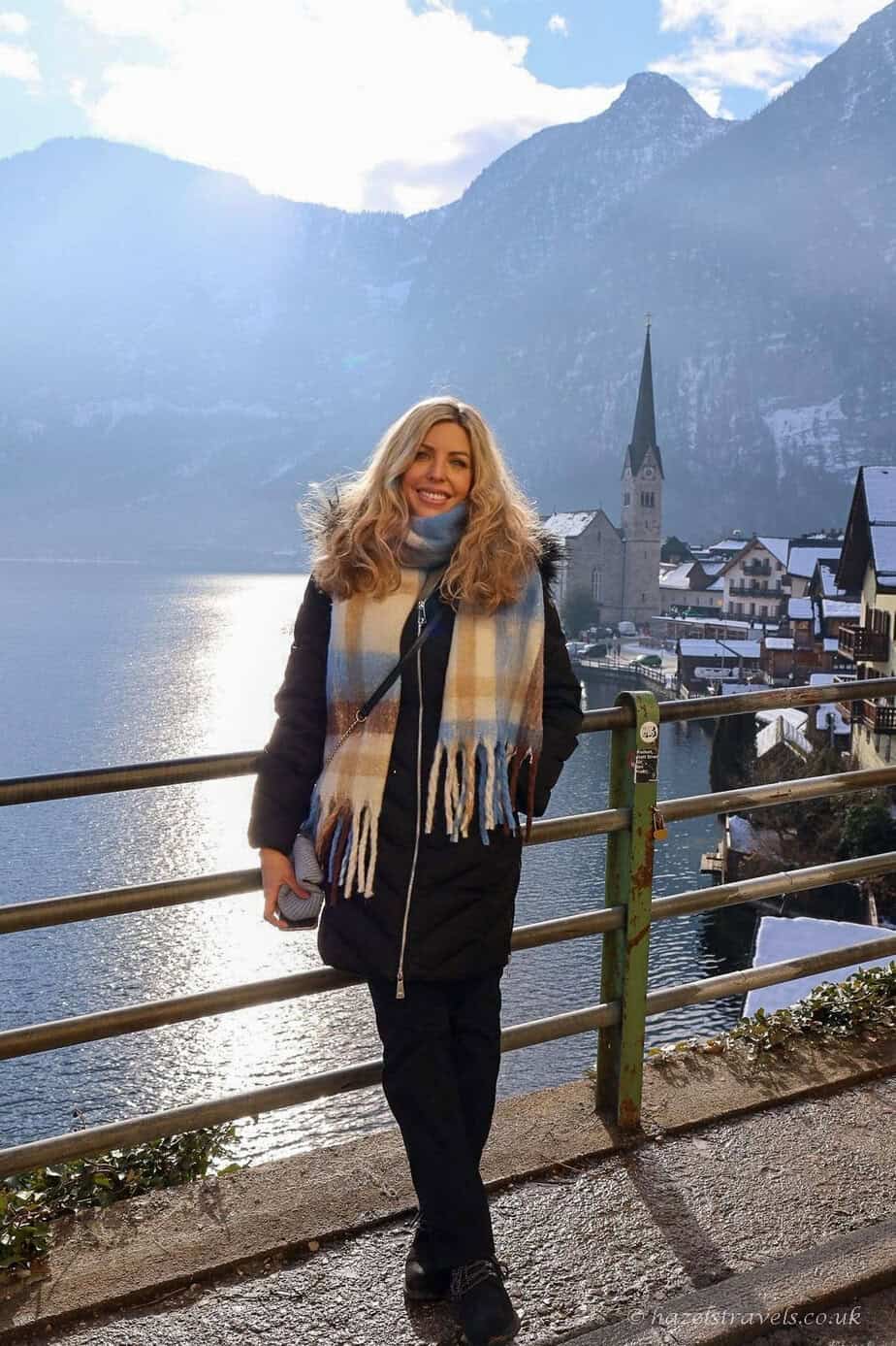 Woman standing beside Lake Hallstatt during a winter visit to Hallstatt, Austria.