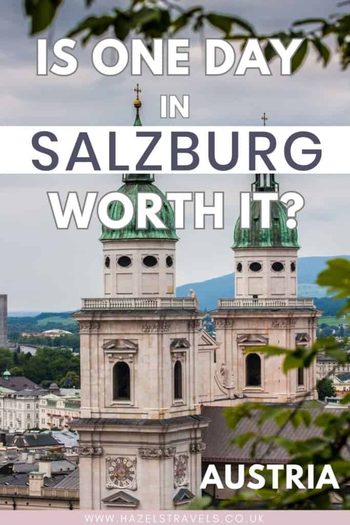 Salzburg Cathedral twin green copper domes rising above the old town rooftops with Alpine hills in the background, framed by leafy branches, Salzburg Austria. Text overlay reads :"Is one day in Salzburg worth it?"