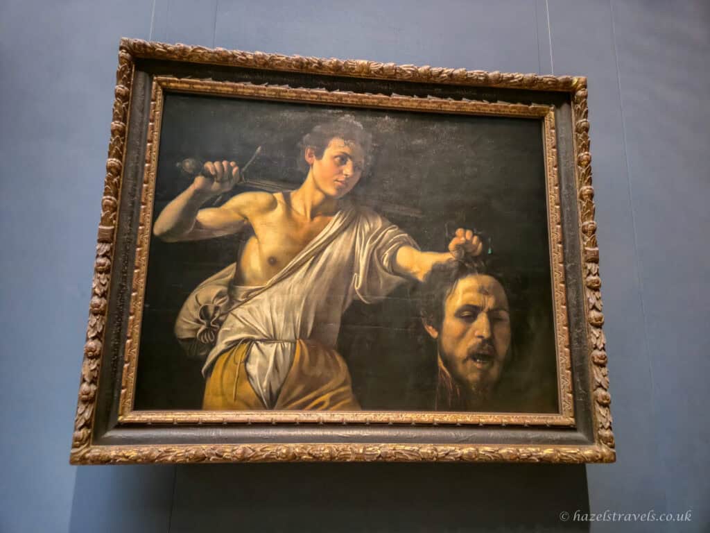 The painting “David with the Head of Goliath” by Caravaggio depicting David holding the severed head of the giant after the battle.