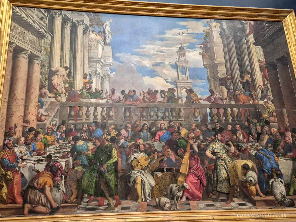 The Wedding Feast at Cana by Paolo Veronese in the Louvre Museum Paris, showing a large Renaissance banquet scene with many figures, architecture, and vibrant colours.